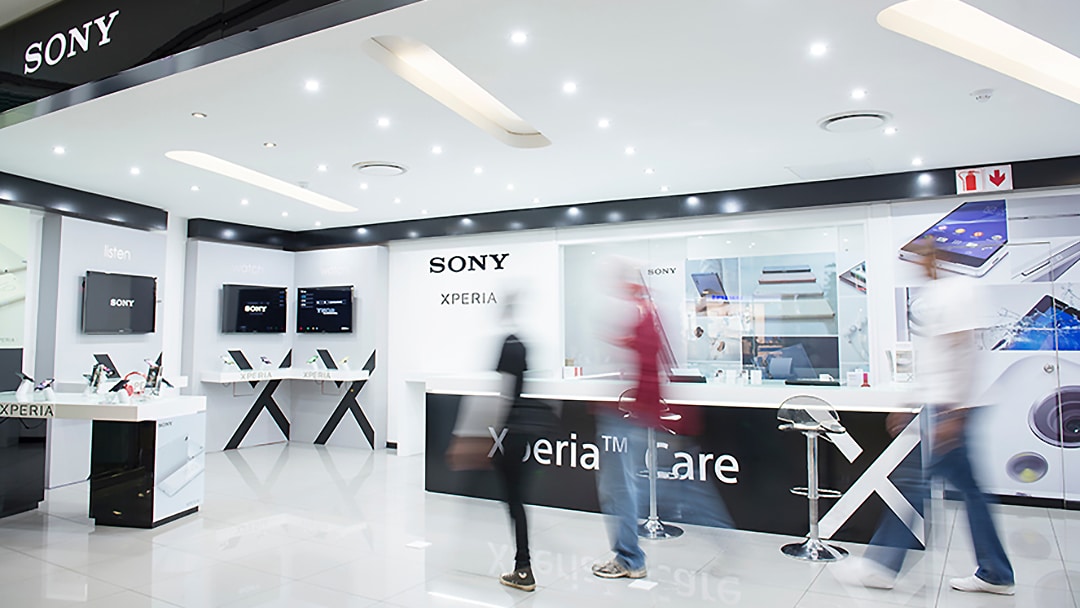 Sony Mobile shop interior with blurred people walking in the foreground