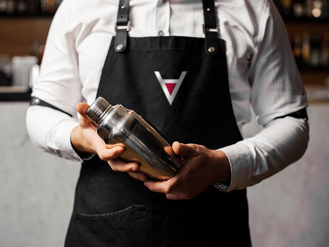 The Martini: bartender with branded apron and shaker