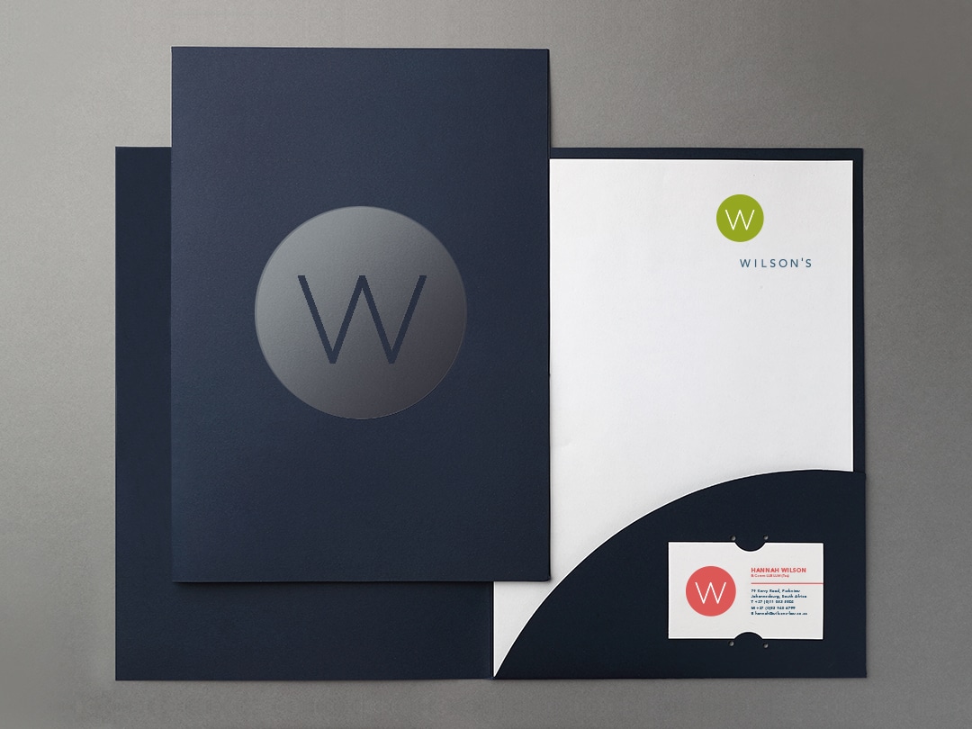 Design of Wilson's Attorneys folder with varnished icon on cover, and letterhead and business card inside