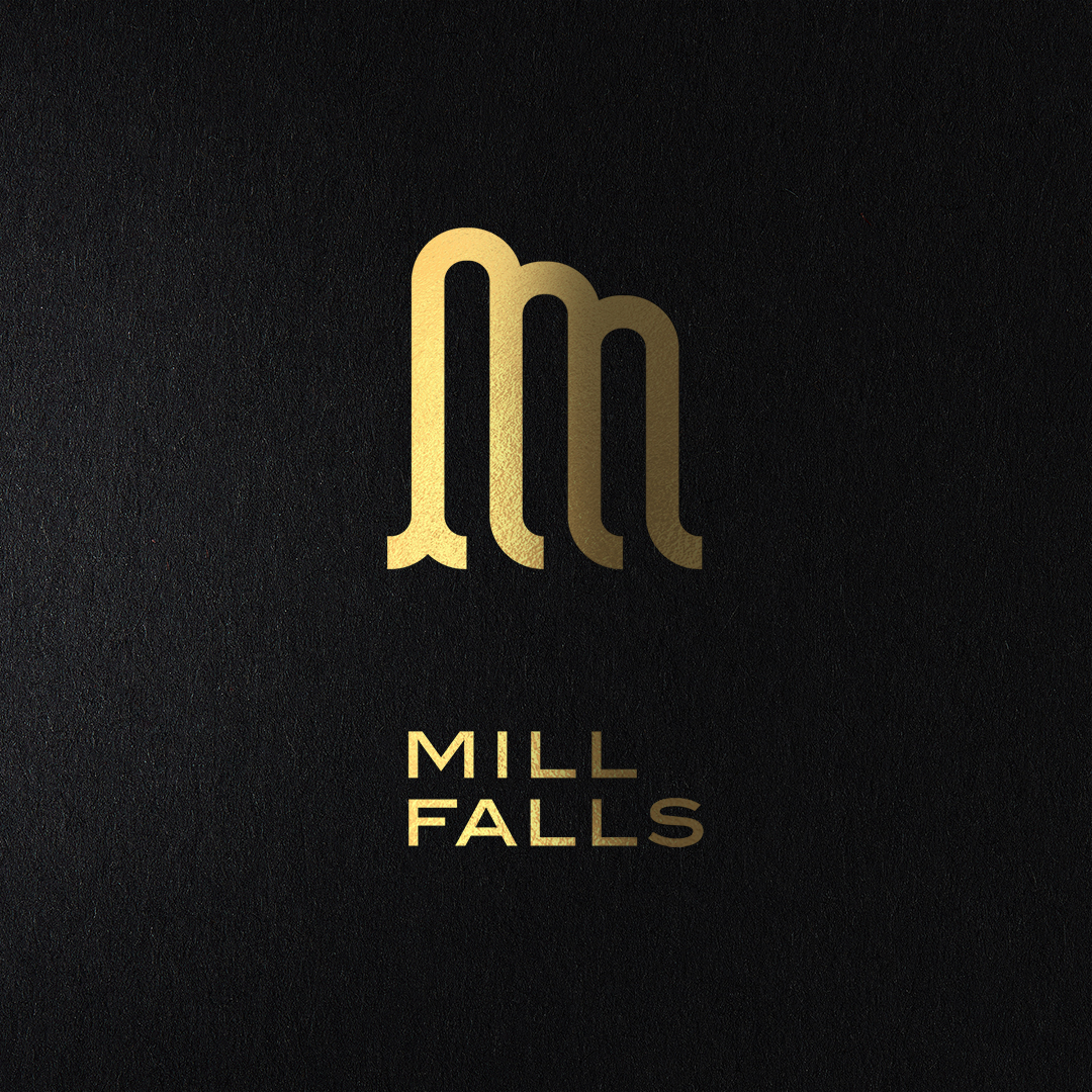 Mill Falls gold logo on black board