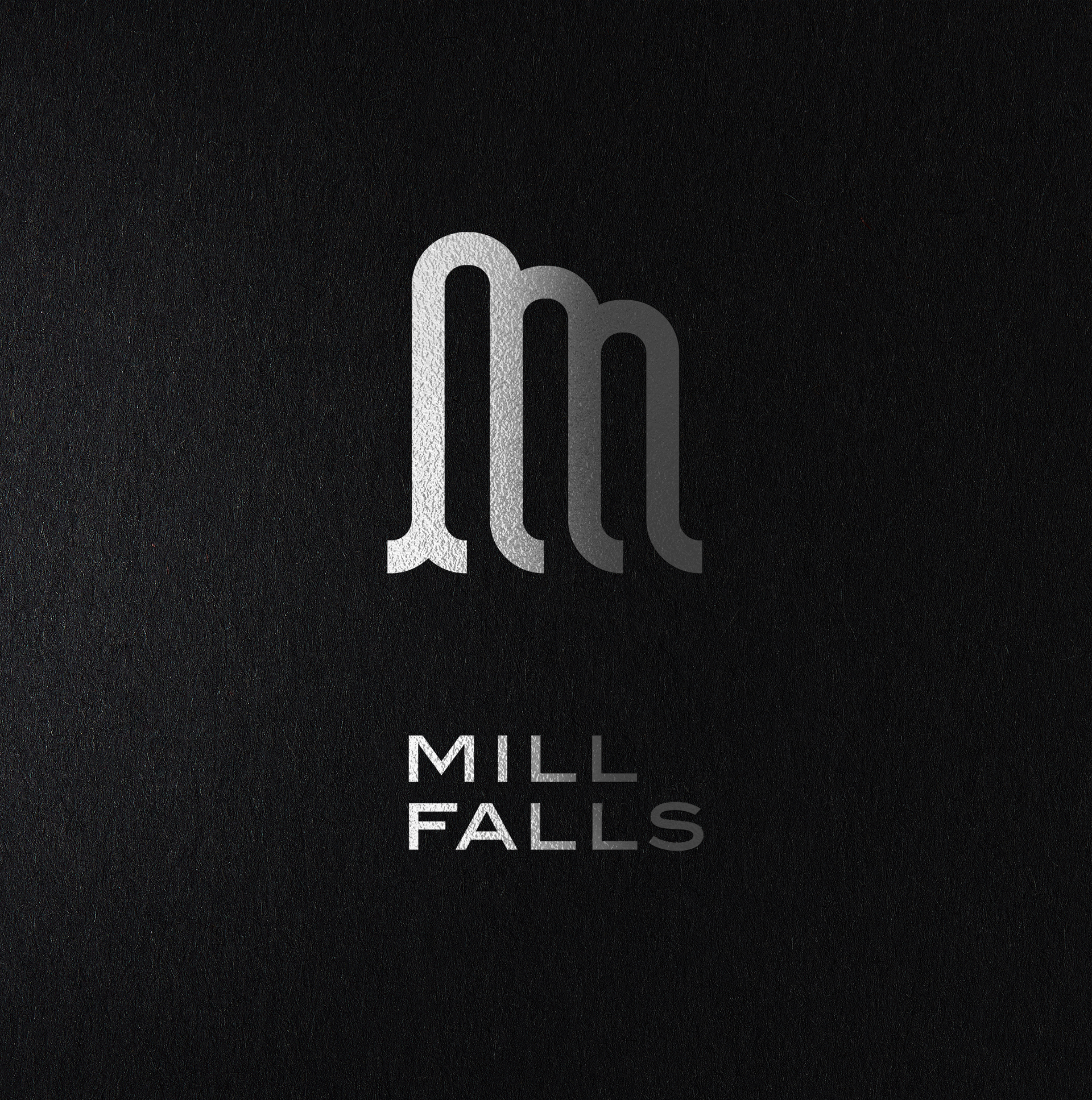 Mill Falls silver logo on black board