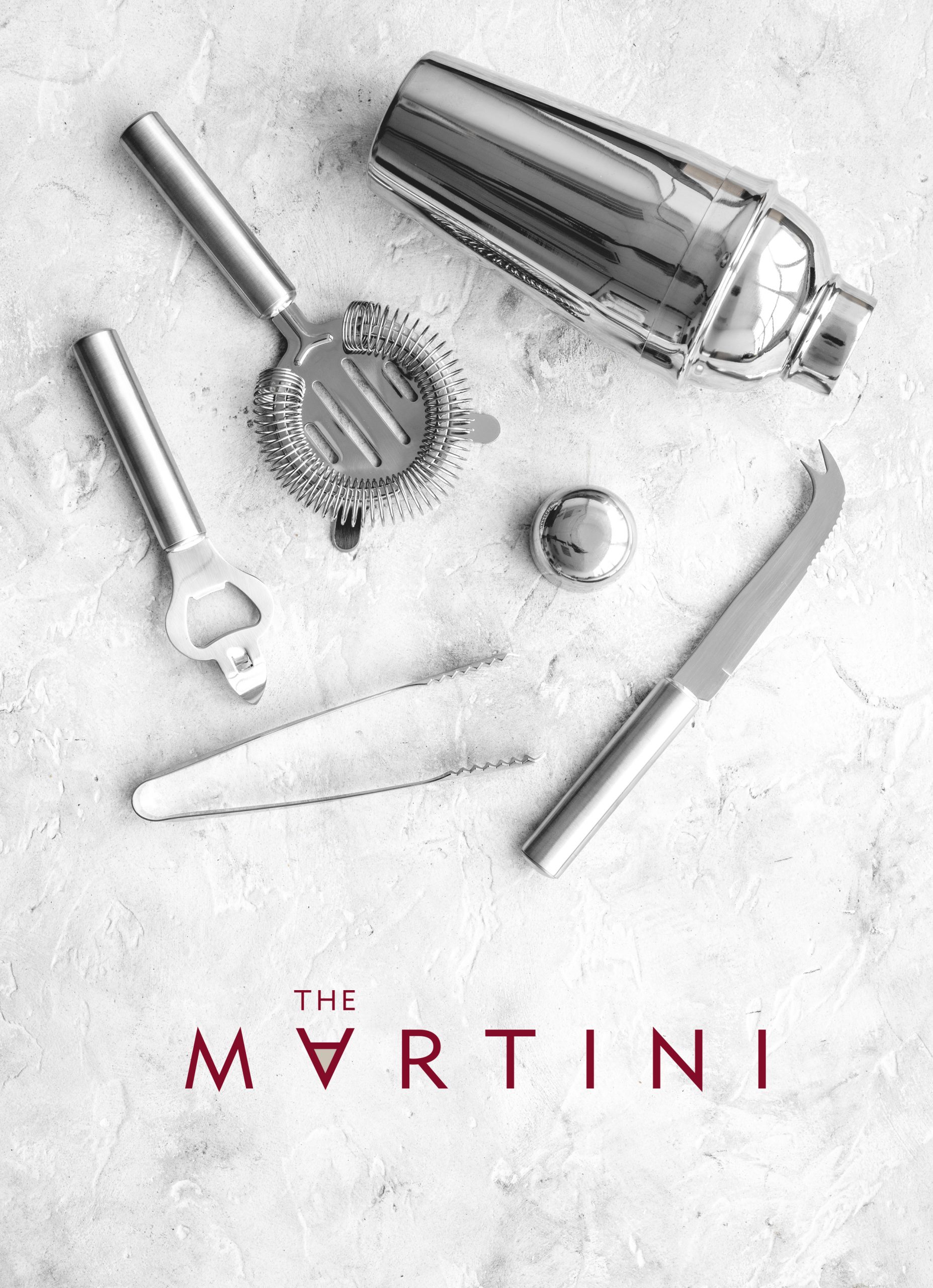 The Martini logo placed over an image of cocktail-making equipment on a marble countertop.